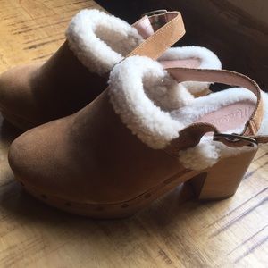 sheeplined clog heels with adjustable straps.